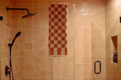 a shower with a checkered shower curtain in a bathroom at Mane & Saddle Loft in Los Angeles