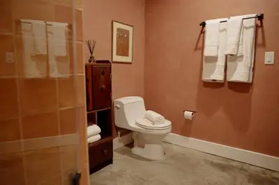 a bathroom with a toilet and a shower with towels at Mane & Saddle Loft in Los Angeles