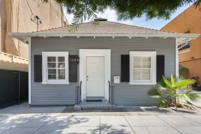 a small gray house with a white door and windows at Adorable Pasadena Bungalow in Pasadena