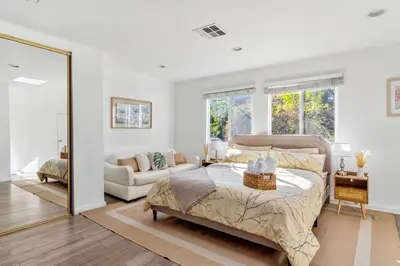 a bedroom with a bed and a living room at Quiet Home with Spectacular Scenic Mountain Views near Universal Studios Hollywood in Los Angeles