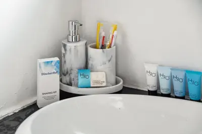 a bathroom withbranded products on a counter next to a toilet at Quiet Home with Spectacular Scenic Mountain Views near Universal Studios Hollywood in Los Angeles