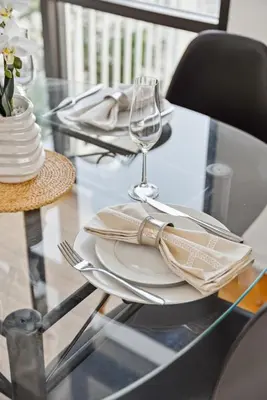 a glass table with plates and a wine glass at Quiet Home with Spectacular Scenic Mountain Views near Universal Studios Hollywood in Los Angeles