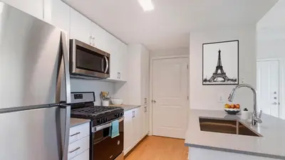 a kitchen with a refrigerator and a stove top oven at The Hideaway in MDR, FREE Parking, Heated Pool in Los Angeles