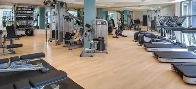 a gym with a row of treadmills and machines at The Hideaway in MDR, FREE Parking, Heated Pool in Los Angeles