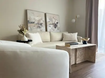 a living room with a white couch and a table at The Hideaway in MDR, FREE Parking, Heated Pool in Los Angeles