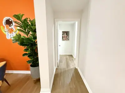 an empty hallway with orange walls and a plant at 3BR Retreat in Prime Valley Location 109 in Encino