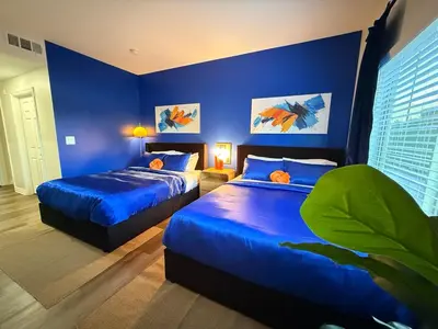two beds in a room with blue walls at 3BR Retreat in Prime Valley Location 109 in Encino
