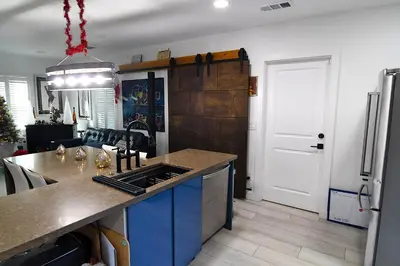 a kitchen with a counter top and a refrigerator at Urban Oasis in Los Angeles