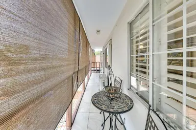 a balcony with a table and a large window at Fullerton Home Base Easy Access to Dtwn and CSUF! in Fullerton