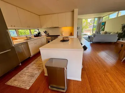 a kitchen with a white island in the middle of a room at Venice Walk Street Retreat Jacuzzi and Lemon Tree in Los Angeles