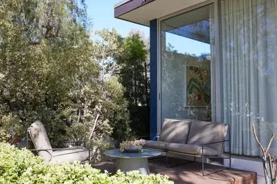 a patio with two chairs and a table at Architectural Walk Street Home Venice Elegance in Los Angeles
