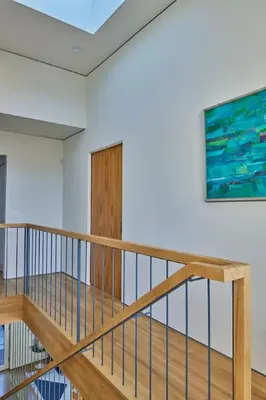 a staircase in a house with a painting on the wall at Architectural Walk Street Home Venice Elegance in Los Angeles
