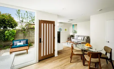 a kitchen and living room with a table and chairs at Modern Mar Vista Hideaway New TwoStory ADU in Los Angeles