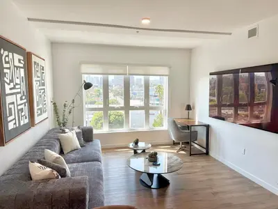 a living room with a couch and a table at Westwood Penthouse 3 Bedroom 2 Bath w Gym, Balcony, Parking in Los Angeles