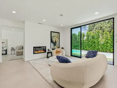 a living room with a couch and a large window at Casa Leona in Los Angeles