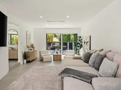 a living room with a large couch and a living room with at Casa Leona in Los Angeles