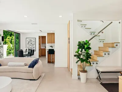 a living room with a couch and stairs at Casa Leona in Los Angeles