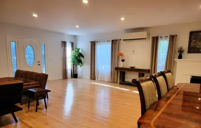 a living room with a table and a dining room at Private and large 2 bedroom house with Pool table, backyard and office near attractions in Los Angeles