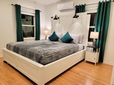 a bedroom with a large bed with blue pillows at Private and large 2 bedroom house with Pool table, backyard and office near attractions in Los Angeles