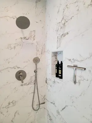 a shower in a bathroom with a white marble wall at Private and large 2 bedroom house with Pool table, backyard and office near attractions in Los Angeles