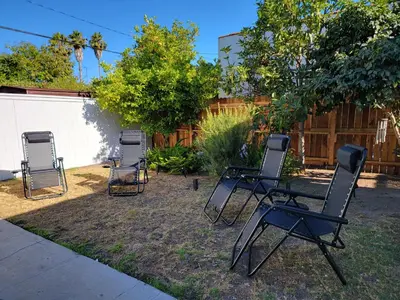a group of chairs sitting in a yard at Private and large 2 bedroom house with Pool table, backyard and office near attractions in Los Angeles