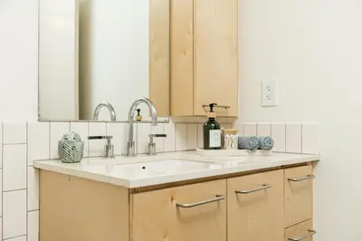 a bathroom counter with a sink and a mirror at Spectacular LOFT in Heart of LA with GYM, Pool, parking in Los Angeles