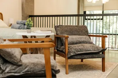 a living room with a chair and a table at Spectacular LOFT in Heart of LA with GYM, Pool, parking in Los Angeles