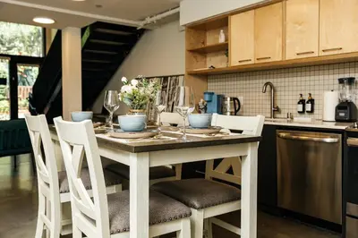 a kitchen with a table with chairs and wine glasses at Spectacular LOFT in Heart of LA with GYM, Pool, parking in Los Angeles