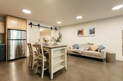 a kitchen and living room with a table and a couch at Spectacular LOFT in Heart of LA with GYM, Pool, parking in Los Angeles