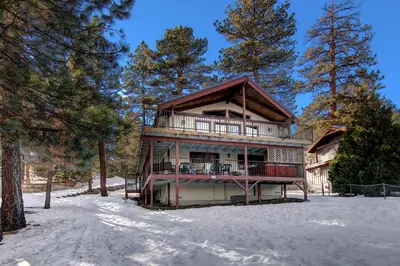 a log home in the snow with trees at Gold Rush in Big Bear Lake