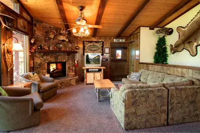 a living room with a couch and a fireplace at Gold Rush in Big Bear Lake