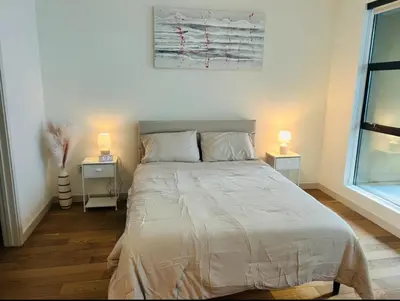 a bedroom with a large bed with two night stands at Chic Hollywood Dream Large Studio in Los Angeles