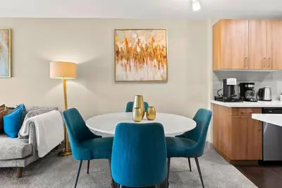 a living room with a table and blue chairs at Moonstone Quiet Retreat Marina Side Garden view in Los Angeles