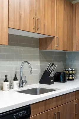a kitchen counter with a sink and wooden cabinets at Moonstone Quiet Retreat Marina Side Garden view in Los Angeles