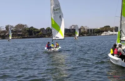 a group of people on small sailboats in the water at Moonstone Quiet Retreat Marina Side Garden view in Los Angeles