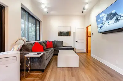 a living room with a couch and a flat screen tv at Sleeps 10 Cozy Modern Cabin 4 bedroom 3 bath 2400 sq ft 3 story Updated Quiet cabin in Crestline