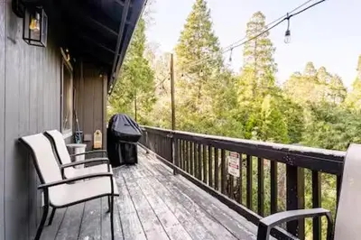a porch with chairs and a view of the woods at Sleeps 10 Cozy Modern Cabin 4 bedroom 3 bath 2400 sq ft 3 story Updated Quiet cabin in Crestline