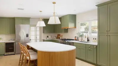a kitchen with green cabinets and a white counter top at Modern and Charming Luxe Home in Los Angeles in Altadena