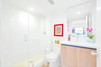 a bathroom with a shower and a toilet and a sink at H- Fab Family 5BD 4,5BA NoHo Escape Near Universal with Games, Deck, Parking in North Hollywood