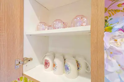 a shelf with a bunch of glass dishes on it at H- Fab Family 5BD 4,5BA NoHo Escape Near Universal with Games, Deck, Parking in North Hollywood