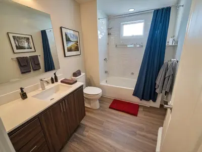 a bathroom with a sink and a toilet and a shower at Urban Chic residence in Central LA in Los Angeles