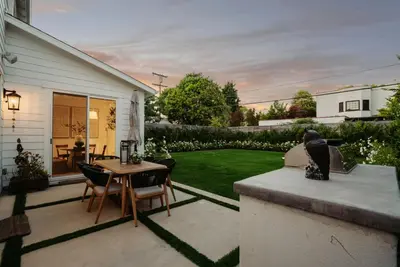 a patio with a table and chairs in a yard at 4mil WestLA Lux Manor Santa Monica and Beverly Hills in Los Angeles