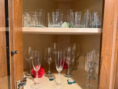 a bunch of wine glasses sitting on a shelf at Cozy Cabin in Crestline