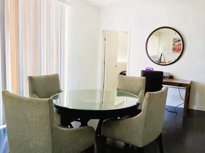 a dining room with a glass table and chairs at Venice Beach Getaway Steps from the Ocean Marina and Boardwalk in Los Angeles