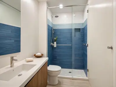 a bathroom with a toilet and a glass shower at Venice Beach Getaway Steps from the Ocean Marina and Boardwalk in Los Angeles