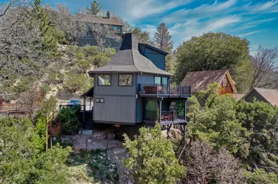 a house on top of a hill with trees at Koda House in Lake Arrowhead