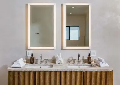 a bathroom with two sinks and a mirror at Amara by Stay Awhile Villas in Los Angeles