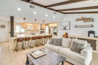 a living room with a couch and a bar at Patio, Fire Pit and Hillside Views Agua Dulce Home in Leona Valley