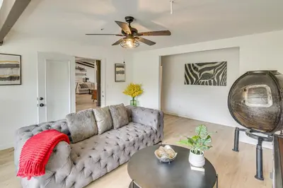 a living room with a couch and a table at Patio, Fire Pit and Hillside Views Agua Dulce Home in Leona Valley