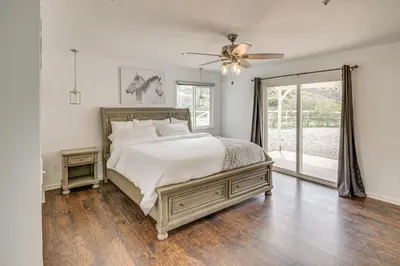 a bedroom with a bed and a ceiling fan at Patio, Fire Pit and Hillside Views Agua Dulce Home in Leona Valley
